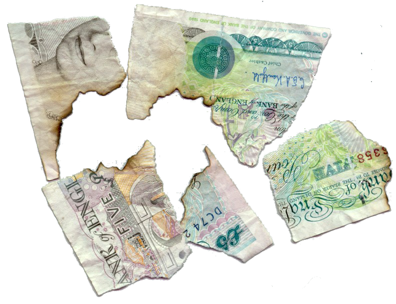 Burnt and crumpled fragments of British fiver GBP5 five pound note after accident 